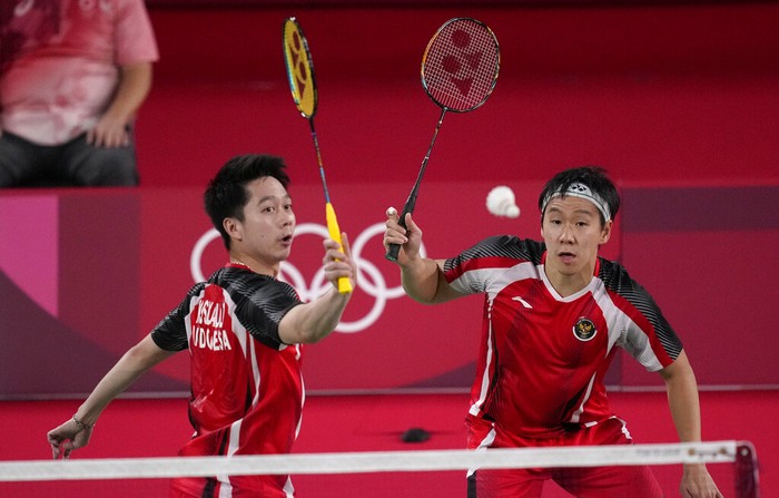 Indonesias Marcus Gideon and Kevin Sanjaya Sukamuljo play against Taiwans Lee Yang and Wang Chi-Lin during their mens doubles group play stage badminton match at the 2020 Summer Olympics, Tuesday, July 27, 2021, in Tokyo, Japan. (AP Photo/Dita Alangkara)