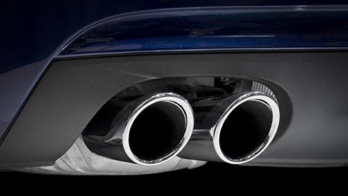 Chrome exhaust pipes on a blue car.