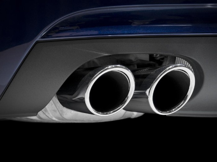 Chrome exhaust pipes on a blue car.
