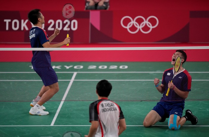 Taiwans Lee Yang, left, and Wang Chi-Lin celebrate after wining against Indonesias Mohammad Ahsan and Hendra Setiawan during their mens doubles badminton semifinal match at the 2020 Summer Olympics, Friday, July 30, 2021, in Tokyo, Japan. (AP Photo/Dita Alangkara)