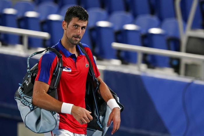 Novak Djokovic, of Serbia, reacts after being defeated by Alexander Zverev, of Germany, during a semifinals match of the tennis competition at the 2020 Summer Olympics, Friday, July 30, 2021, in Tokyo, Japan. (AP Photo/Seth Wenig)