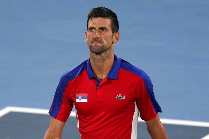 Novak Djokovic, of Serbia, reacts after being defeated by Alexander Zverev, of Germany, during a semifinals match of the tennis competition at the 2020 Summer Olympics, Friday, July 30, 2021, in Tokyo, Japan. (AP Photo/Seth Wenig)