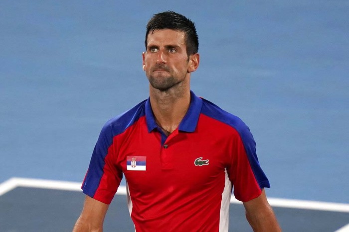Tokyo Olympics Tennis Novak Djokovic, of Serbia, reacts after being defeated by Alexander Zverev, of Germany, during a semifinals match of the tennis competition at the 2020 Summer Olympics, Friday, July 30, 2021, in Tokyo, Japan. (AP Photo/Seth Wenig)