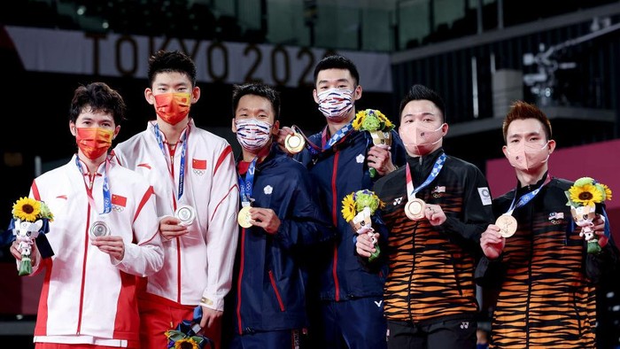 CHOFU, JAPAN - JULY 31:  (L-R) Silver medalists Li Jun Hui and Liu Yu Chen of Team China, gold medalists Lee Yang and Wang Chi-Lin of Team Chinese Taipei and bronze medalists Aaron Chia and Soh Wooi Yik of Team Malaysia pose on the podium during the medal ceremony for the Mens Doubles badminton event on day eight of the Tokyo 2020 Olympic Games at Musashino Forest Sport Plaza on July 31, 2021 in Chofu, Tokyo, Japan.  (Photo by Lintao Zhang/Getty Images)