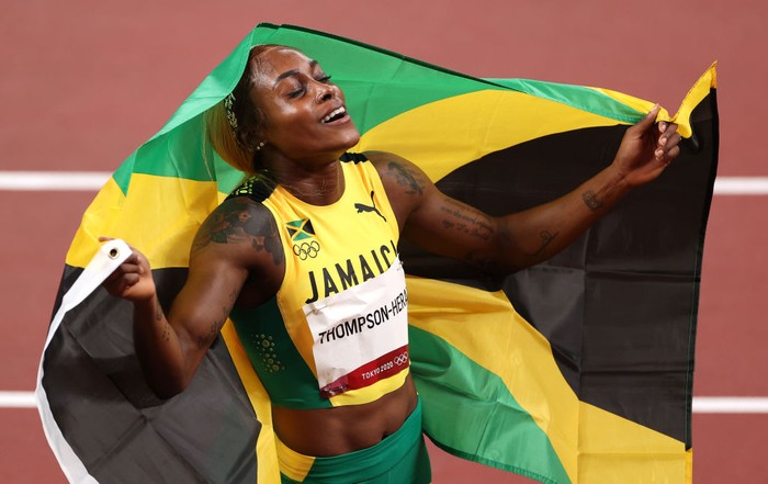Elaine Thompson-Herah TOKYO, JAPAN - JULY 31: Elaine Thompson-Herah of Team Jamaica celebrates after winning the gold medal in the Womens 100m Final on day eight of the Tokyo 2020 Olympic Games at Olympic Stadium on July 31, 2021 in Tokyo, Japan. (Photo by David Ramos/Getty Images)