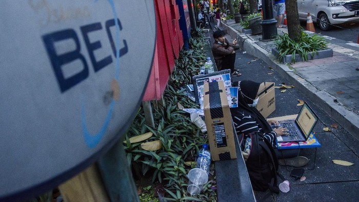 Pedagang komputer berjualan di depan Mal Bandung Electronic Center Bandung, Jawa Barat, Sabtu (31/7/2021). Sejumlah pedagang yang membuka toko di Mal Bandung Electronic Center tersebut terpaksa menggunakan bahu jalan dalam berjualan dan melayani perbaikan gawai dan laptop pelanggan akibat belum adanya lapak pengganti selama mal dan pusat perbelanjaan ditutup di masa PPKM. ANTARA FOTO/Novrian Arbi/wsj.