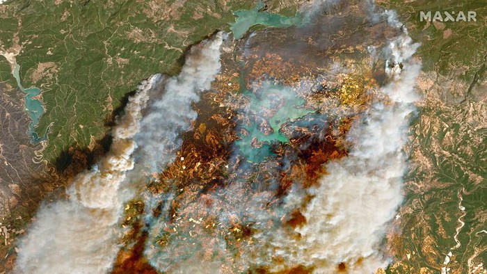 Smoke rises from a forest fire, threatening a residential area in the Aegean coastal town of Bodrum, Turkey, Thursday, July 29, 2021. Turkish authorities on Thursday began investigating the cause of a string of forest fires in Turkey's Mediterranean and southern Aegean regions, including two near the coastal resort town of Manavgat that killed three people and sent over 50 others to hospitals as homes burned down. (IHA via AP)
