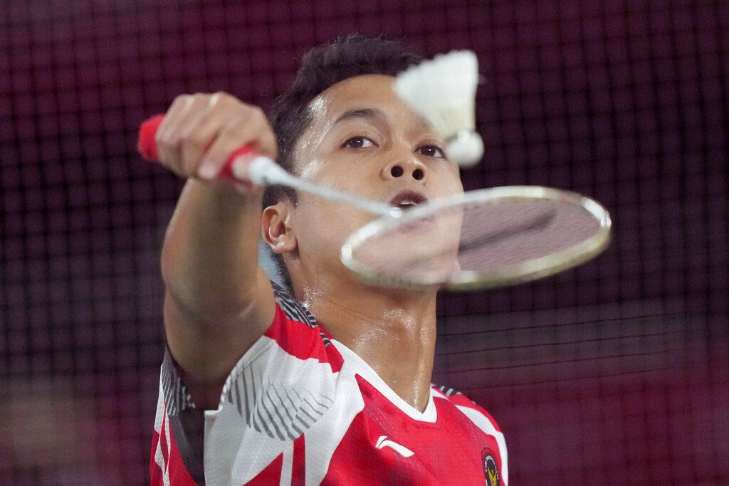 Indonesia's Anthony Sinisuka Ginting competes against China's Chen Long during their men's singles badminton semifinal match at the 2020 Summer Olympics, Sunday, Aug. 1, 2021, in Tokyo, Japan. (AP Photo/Dita Alangkara)