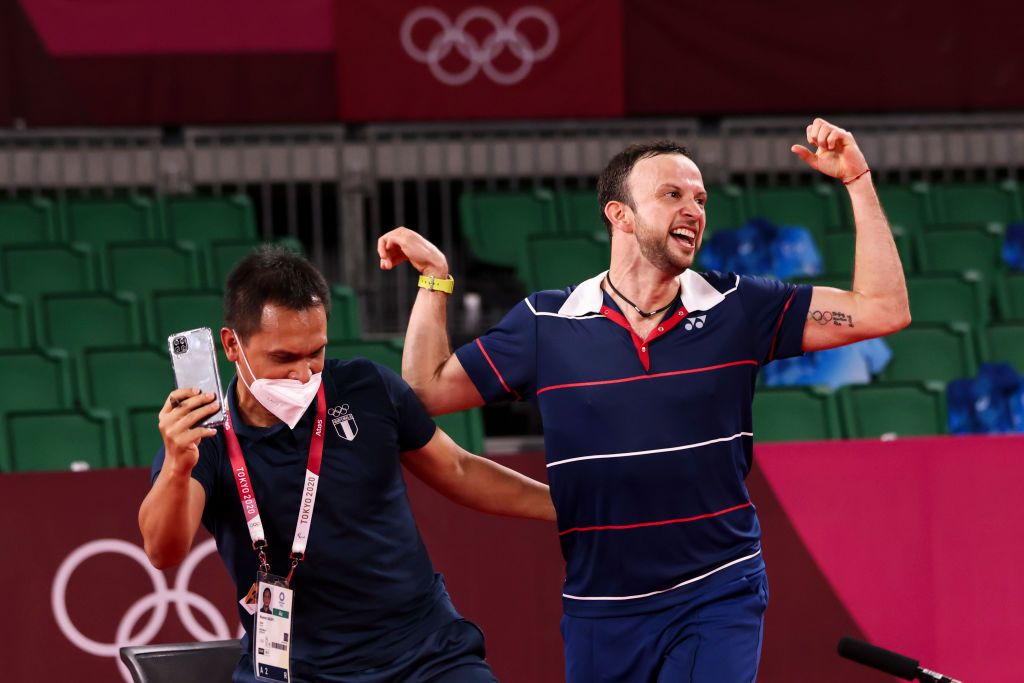 CHOFU, JAPAN - JULY 29: Kevin Cordon of Team Guatemala celebrates with his coach Muamar Qadafi(left) after his victory against Mark Caljouw of Team Netherlands during a Men's Singles Round of 16 match on day six of the Tokyo 2020 Olympic Games at Musashino Forest Sport Plaza on July 29, 2021 in Chofu, Tokyo, Japan. (Photo by Lintao Zhang/Getty Images)