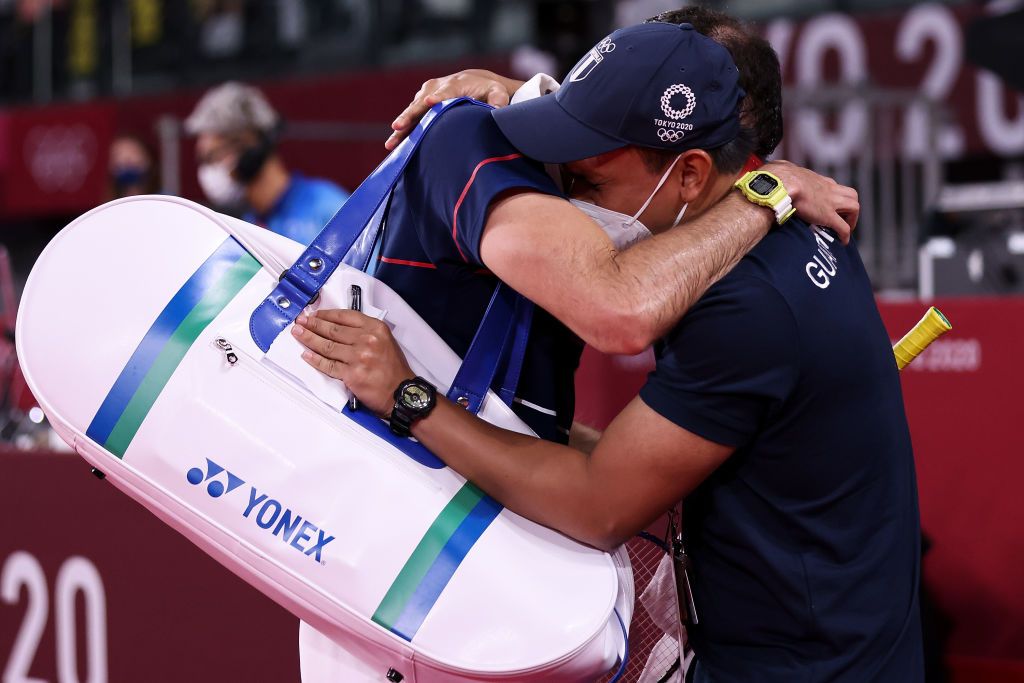 CHOFU, JAPAN - JULY 29: Kevin Cordon of Team Guatemala celebrates with his coach Muamar Qadafi(left) after his victory against Mark Caljouw of Team Netherlands during a Men's Singles Round of 16 match on day six of the Tokyo 2020 Olympic Games at Musashino Forest Sport Plaza on July 29, 2021 in Chofu, Tokyo, Japan. (Photo by Lintao Zhang/Getty Images)
