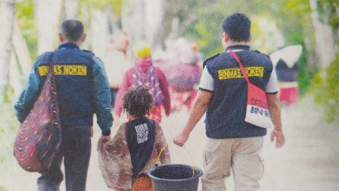 Polisi anggota Binmas Noken berinteraksi dengan anak-anak di Papua