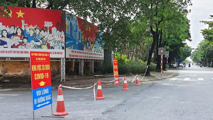 A street is cordoned off to control the traffic in Hanoi, Vietnam, Saturday, July 24, 2021. Vietnam announced a 15-day lockdown in the capital Hanoi starting Saturday as a coronavirus surge spread from the southern Mekong Delta region.  (AP Photo/Hieu Dinh)