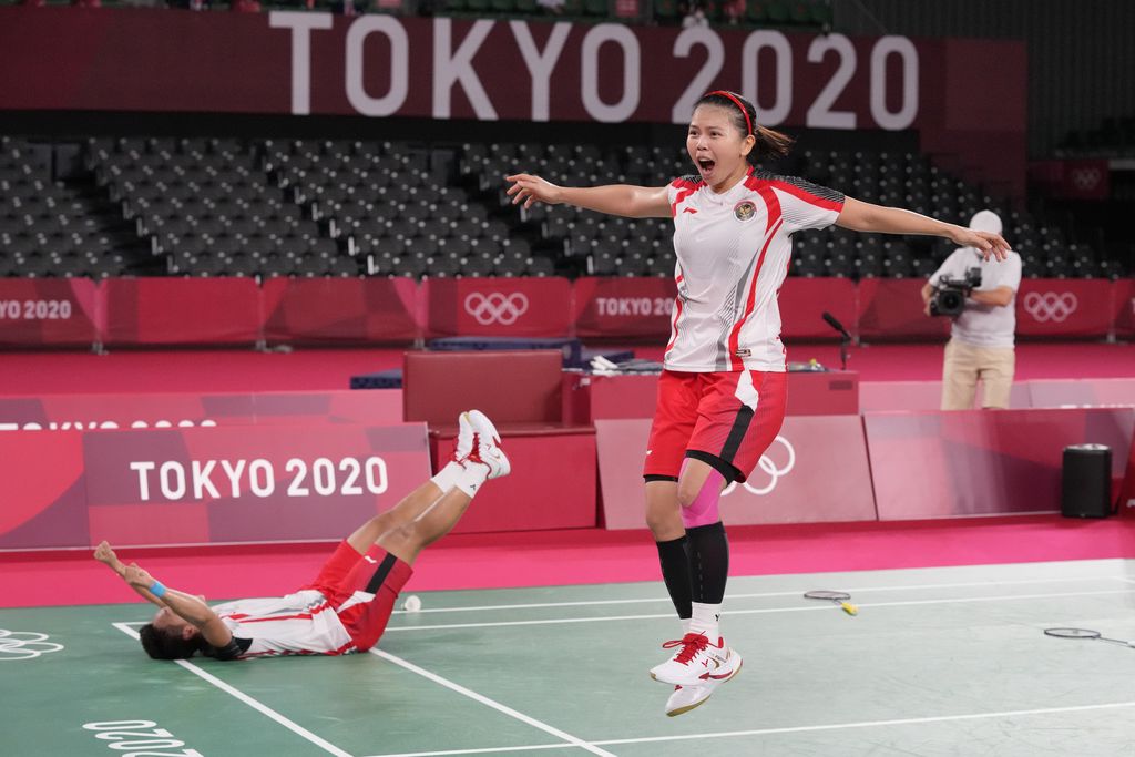 Indonesia's Greysia Polii, right, and Apriyani Rahayu celebrate after defeating China's Chen Qing Chen and Jia Yi Fan during their women's doubles gold medal match at the 2020 Summer Olympics, Monday, Aug. 2, 2021, in Tokyo, Japan. (AP Photo/Dita Alangkara)