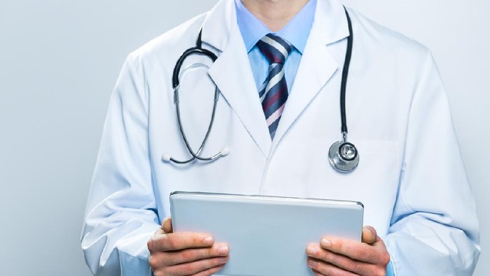 Ilustrasi dokter Doctor using a digital tablet. Technology and medicine concept