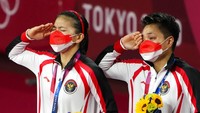 Greysia dan Apriyani meneteskan air matanya saat bendera merah putih dikibarkan. AP Photo/Markus Schreiber.