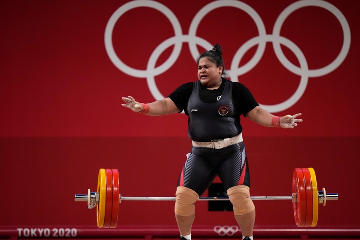 Nurul Akmal of Indonesia drops the barbell during a lift, in the womens +87kg weightlifting event at the 2020 Summer Olympics, Monday, Aug. 2, 2021, in Tokyo, Japan. (AP Photo/Luca Bruno)