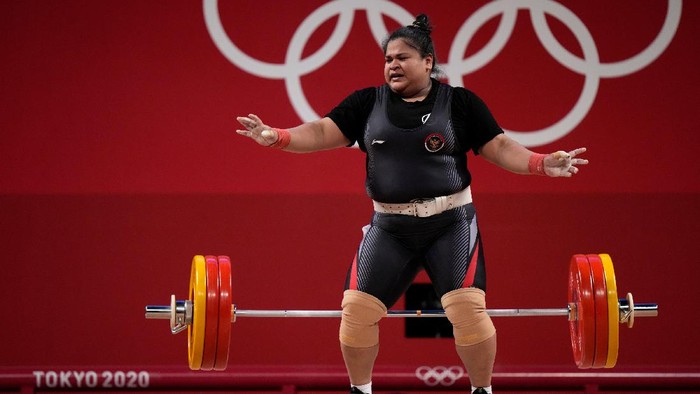 Nurul Akmal of Indonesia drops the barbell during a lift, in the womens +87kg weightlifting event at the 2020 Summer Olympics, Monday, Aug. 2, 2021, in Tokyo, Japan. (AP Photo/Luca Bruno)