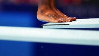 Sebuah tato cincin Olimpiade menghiasi kaki Jennifer Abel, dari Kanada, saat ia bersiap untuk menyelam di babak penyisihan loncatan 3 meter loncatan putri. AP/David Goldman  