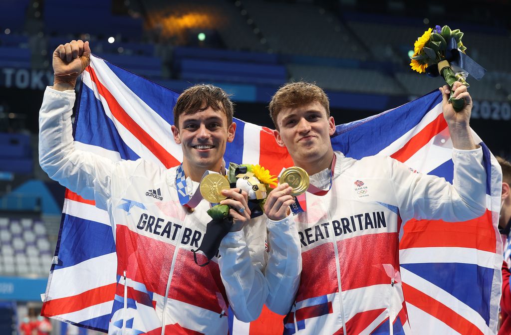 TOKYO, JAPAN - JULY 26: Thomas Daley and Matty Lee of Team Great Britain pose for photographers with their gold medals after winning the Men's Synchronised 10m Platform Final on day three of the Tokyo 2020 Olympic Games at Tokyo Aquatics Centre on July 26, 2021 in Tokyo, Japan. (Photo by Clive Rose/Getty Images)