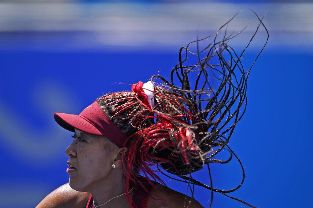 Naomi Osaka, of Japan, plays against Saisai Zheng, of China, during the first round of the tennis competition at the 2020 Summer Olympics, Sunday, July 25, 2021, in Tokyo, Japan. (AP Photo/Seth Wenig)