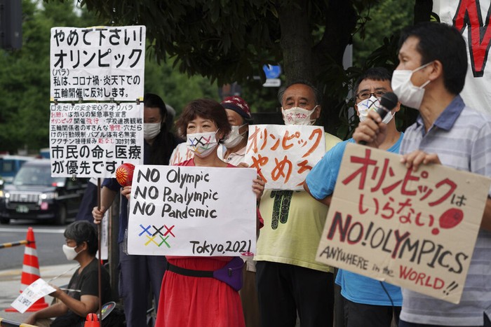 Protesters demonstrate in front of the Prime Minister's Office in Tokyo, Japan, Monday, Aug. 2, 2021. They were protesting against the Olympics and Paralympics held during the pandemic as Japan has expanded a coronavirus state of emergency to Tokyo's neighboring prefectures in addition to the capital, following recent record spikes in infections. (AP Photo/Kantaro Komiya)