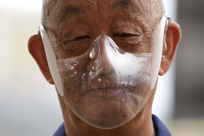 Tokyo Olympics Tennis A volunteer cleans seats meant for spectators at the Ariake Tennis Center ahead of the 2020 Summer Olympics, Friday, July 23, 2021, in Tokyo, Japan. (AP Photo/Seth Wenig)