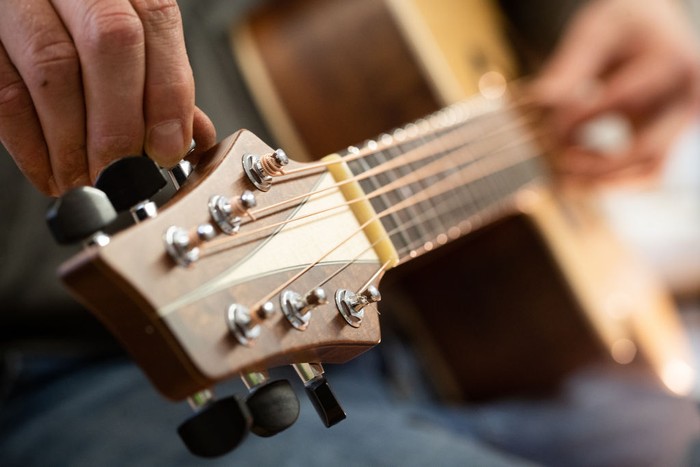 REMAGEN, GERMANY - DECEMBER 11: Master guitar craftsman Tobias Ahlke adjusts the tones on an acoustic guitar body at his workshop on December 11, 2019 in Remagen, Germany. Germany. Ahlke produces acoustic and electric guitars from carefully selected types of wood and needs about 100 working hours to produce a single acoustic guitar. His clients wait up to a year for his Essence brand of custom-made guitars. (Photo by Andreas Rentz/Getty Images)