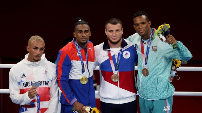 TOKYO, JAPAN - AUGUST 04: Men’s Light Heavy (75-81kg) medalists (L-R) Benjamin Whittaker of Team Great Britain (silver medal), Arlen Lopez of Team Cuba (gold medal), Imam Khataev of Team Russian Olympic Committee (bronze medal) and Loren Berto Alfonso Dominguez of Team Azerbaijan (bronze medal) pose for photographs during the Victory Ceremony on day twelve of the Tokyo 2020 Olympic Games at Kokugikan Arena on August 04, 2021 in Tokyo, Japan. (Photo by Harry How/Getty Images)