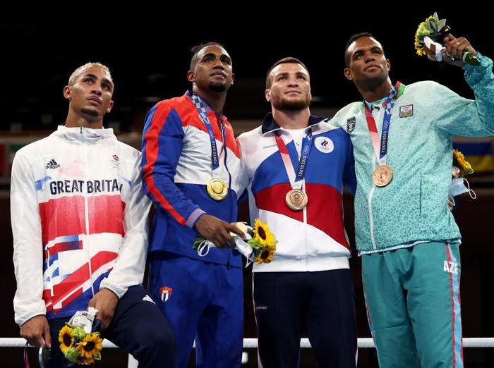 TOKYO, JAPAN - AUGUST 04: Men’s Light Heavy (75-81kg) medalists (L-R) Benjamin Whittaker of Team Great Britain (silver medal), Arlen Lopez of Team Cuba (gold medal), Imam Khataev of Team Russian Olympic Committee (bronze medal) and Loren Berto Alfonso Dominguez of Team Azerbaijan (bronze medal) pose for photographs during the Victory Ceremony on day twelve of the Tokyo 2020 Olympic Games at Kokugikan Arena on August 04, 2021 in Tokyo, Japan. (Photo by Buda Mendes/Getty Images)