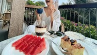 Nginap di sebuah hotel, ini pose lucu Glenca saat menikmati sarapan. Ada beberapa potong cake, kopi, dan semangka untuk sarapan. Foto: Instagram @glencachyasraofficial