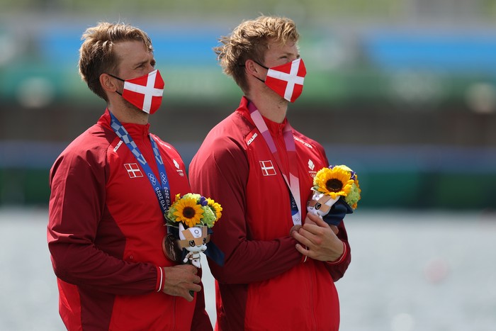 YOKOHAMA, JAPAN - JULY 27: Shimeng Peng #12 of Team China wears a face mask with teammates as they stand for the national anthem prior to the Women's Group F match between Netherlands and China on day four of the Tokyo 2020 Olympic Games at International Stadium Yokohama on July 27, 2021 in Yokohama, Kanagawa, Japan. (Photo by Francois Nel/Getty Images)