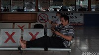 Beberapa warga hanya duduk di ruang keberangkatan sembari menunggu bus jalan.