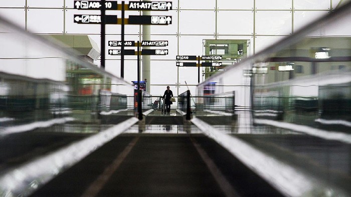 WUHAN, CHINA - APRIL 13: (CHINA OUT) A worker walks on the conveyor belt for passengers in the No. 2 Terminal Building of Wuhan Tianhe Airport on April 13, 2008 in Wuhan of Hubei Province, China. The new No. 2 Terminal Building of Tianhe Airport, which is due to open on April 15, 2008 has a annual passenger handling capacity of 13 million and a cargo handling capacity of 320,000 tons. Its 20 boarding bridges can berth 11 Boeing 737s, eight Boeing 767s and 1 A380 Airbus at the same time. (Photo by China Photos/Getty Images)