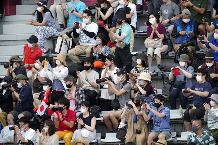 Two women take photos with the Tokyo 2020 Olympic Cauldron, Wednesday, Aug. 4, 2021, in Tokyo, Japan. (AP Photo/Ashley Landis)