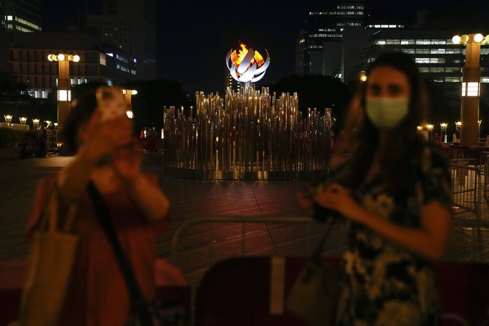 Tokyo Olympics Daily Life Two women take photos with the Tokyo 2020 Olympic Cauldron, Wednesday, Aug. 4, 2021, in Tokyo, Japan. (AP Photo/Ashley Landis)