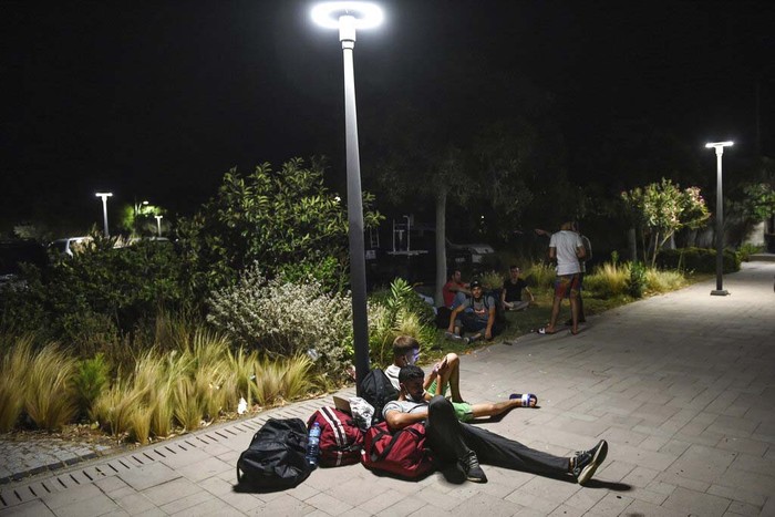 Turkey Wildfires People wait to be evacuated by boats after wildfires reached the Kemerkoy Power Plant, a coal-fueled power plant, in Milas in southwest Turkey, late Wednesday, Aug. 4, 2021. (AP Photo/Cem Tekkesoglu)