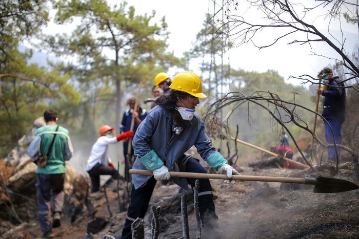 Turkey Wildfires Turkish volunteers rest as they fight wildfires in Turgut village, near tourist resort of Marmaris, Mugla, Turkey, Wednesday, Aug. 4, 2021. As Turkish fire crews pressed ahead Tuesday with their weeklong battle against blazes tearing through forests and villages on the country's southern coast, President Recep Tayyip Erdogan's government faced increased criticism over its apparent poor response and inadequate preparedness for large-scale wildfires.(AP Photo/Emre Tazegul)
