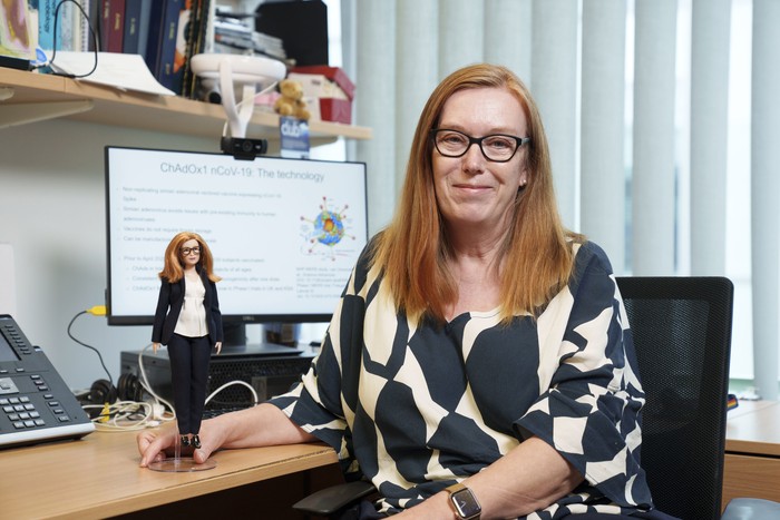In this undated photo issued by Mattel, Britains Professor Sarah Gilbert holds a Barbie doll made in her image, in honour of the Oxford vaccine co-creator. The toy company has created models in honour of five other women working in STEM around the world. (Andy Paradise/Mattel via AP)