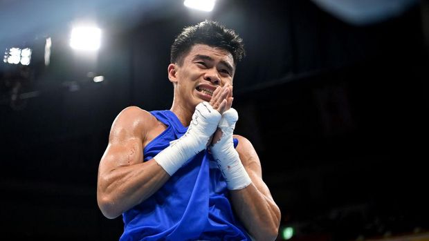 TOKYO, JAPAN - AUGUST 03: Carlo Paalam of Team Philippines celebrates vicrory over Shakhobidin Zoirov of Team Uzbekistan during the Men's Fly (48-52kg) quarter final on day eleven of the Tokyo 2020 Olympic Games at Kokugikan Arena on August 03, 2021 in Tokyo, Japan. (Photo by Luis Robayo - Pool/Getty Images)