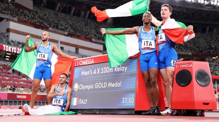 TOKYO, JAPAN - AUGUST 06: Lorenzo Patta, Lamont Marcell Jacobs, Eseosa Fostine Desalu and Filippo Tortu of Team Italy celebrate winning the gold medal in the Mens 4 x 100m Relay Final on day fourteen of the Tokyo 2020 Olympic Games at Olympic Stadium on August 06, 2021 in Tokyo, Japan. (Photo by Michael Steele/Getty Images)