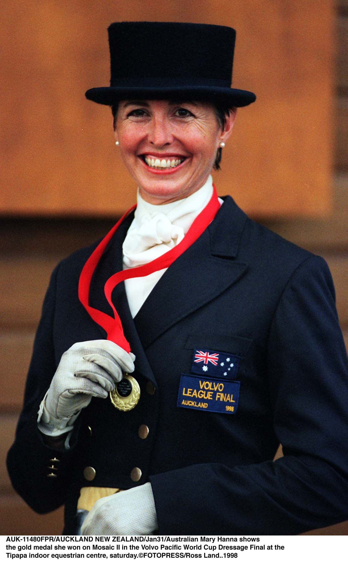 AUCKLAND, NEW ZEALAND - JANUARY 31:  Australian Mary Hanna shows rthe gold medal she won on Mosaic II in the Volvo Pacific World Cup Dressage Final at the rTipapa indoor equestrian centre, saturday.  (Photo by Ross Land/Getty Images)