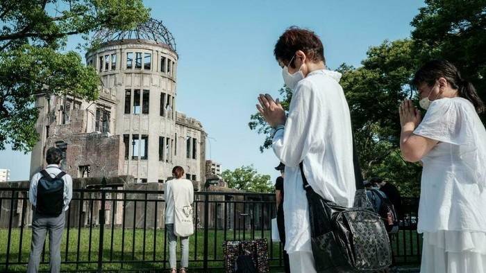 People offer prayers by the Atomic Bomb Dome in Hiroshima (Yasuyoshi CHIBA/AFP)
