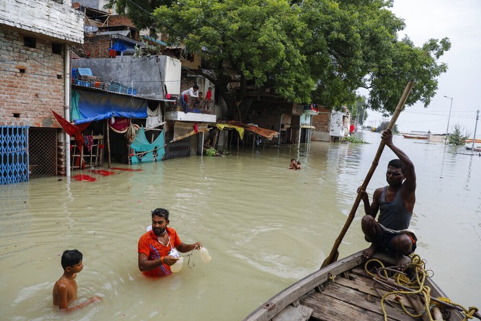 A man rows his boat through a flooded river Ganges following heavy monsoon rains in Prayagraj, India, Saturday, Aug. 7, 2021. (AP Photo/Rajesh Kumar Singh)