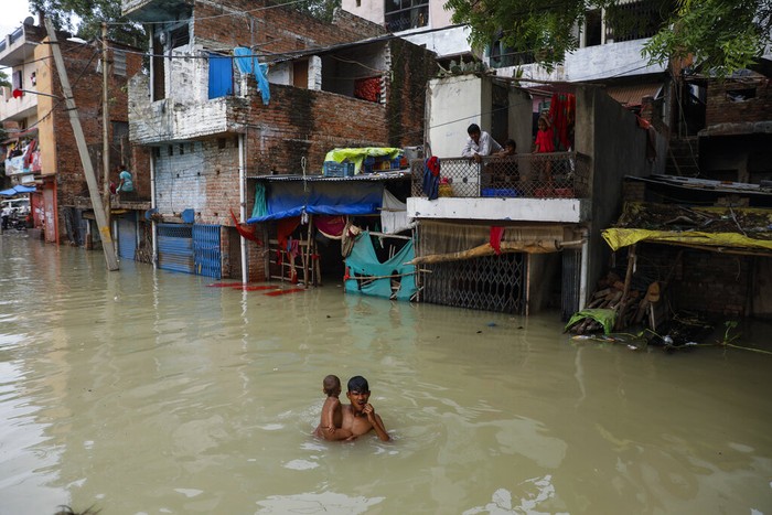 A man rows his boat through a flooded river Ganges following heavy monsoon rains in Prayagraj, India, Saturday, Aug. 7, 2021. (AP Photo/Rajesh Kumar Singh)