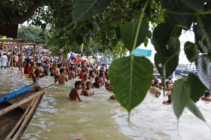India Monsoon Floods A man rows his boat through a flooded river Ganges following heavy monsoon rains in Prayagraj, India, Saturday, Aug. 7, 2021. (AP Photo/Rajesh Kumar Singh)