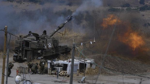 Israeli forces fire artillery from their position on the border with Lebanon after a barrage of rockets were fired from Lebanon, Friday, Aug. 6, 2021. The militant Hezbollah group said it fired rockets near Israeli positions close to the Lebanese border, calling it retaliation for Israeli airstrikes on southern Lebanon a day earlier. (Ayal Margolin/JINIPIX via AP)