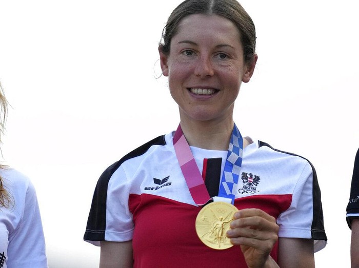 Anna Kiesenhofer of Austria holds her gold medal during a medal ceremony for the womens cycling road race at the 2020 Summer Olympics, Sunday, July 25, 2021, in Oyama, Japan. (AP Photo/Christophe Ena)