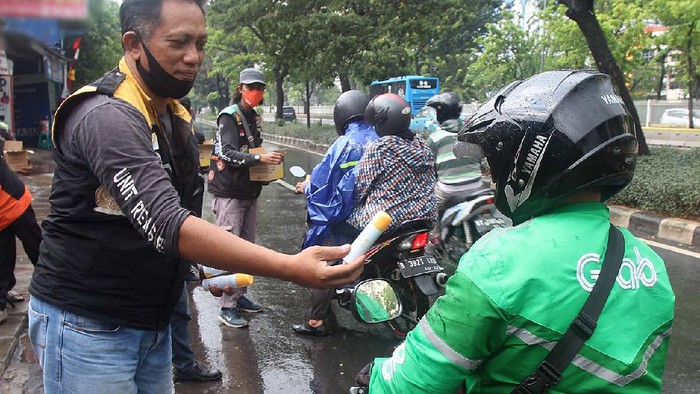 Berbagai cara dilakukan orang untuk berbagai di masa pandemi ini. Termasuk membagikan hand sanitizer untuk para pengemudi ojek online.