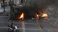 Sebuah mobil dibakar massa dalam aksi yang berujung ricuh.