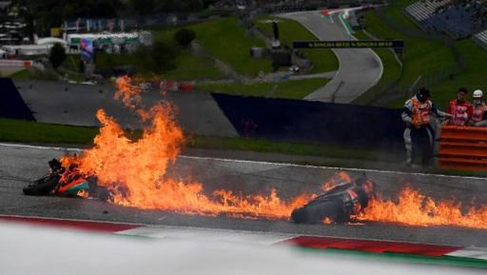 Dani Pedrosa, Lorenzo Savadori Motorbikes are on fire following a crash involving Aprilia Italian rider Lorenzo Savadori and KTM Spanish rider Dani Pedrosa after the start of the Styrian Motorcycle Grand Prix at the Red Bull Ring race track in Spielberg, Austria on August 8, 2021. (Photo by JOE KLAMAR / AFP)